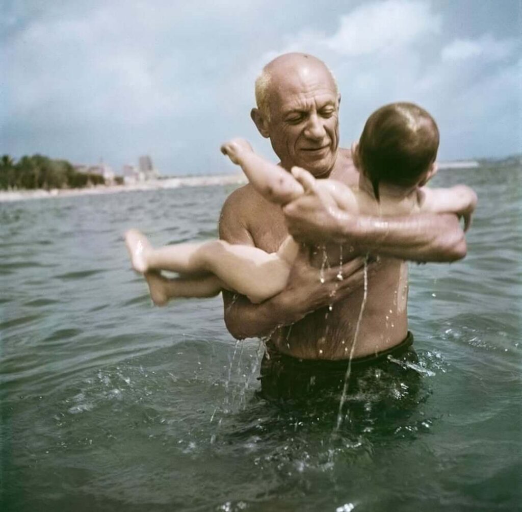 Pablo Picasso playing in the water with his son Claude, Vallauris, France, 1948. © Robert Capa/International Center of Photography/Magnum Photos.